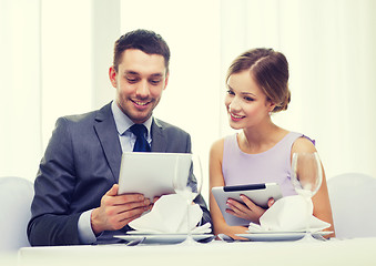 Image showing couple with menus on tablet pc at restaurant