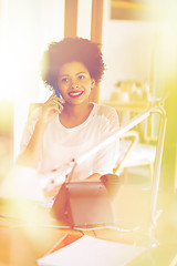 Image showing businesswoman calling on smartphone at office