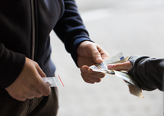 Image showing close up of addict buying dose from drug dealer