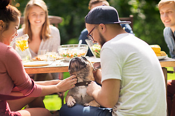 Image showing happy friends having dinner at summer garden party