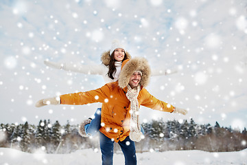 Image showing happy couple having fun over winter background