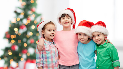 Image showing happy little children in christmas santa hats