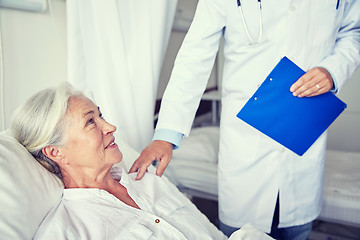 Image showing doctor visiting happy senior woman at hospital