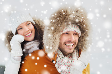 Image showing happy couple having fun over winter background