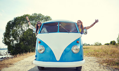 Image showing smiling young hippie women driving minivan car