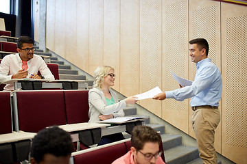 Image showing teacher giving tests to students at lecture