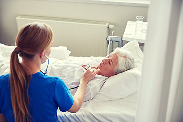 Image showing nurse with stethoscope and senior woman at clinic