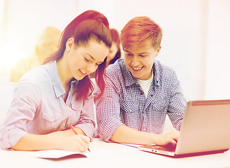 Image showing students with laptop and notebooks at school