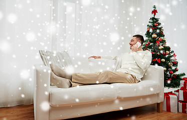 Image showing man calling on smartphone at home for christmas