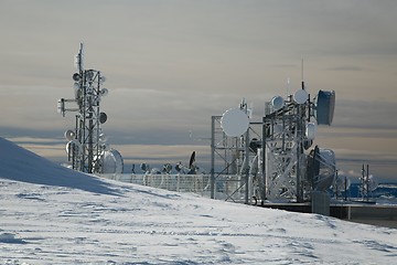 Image showing Transmitter towers on a hill in winter