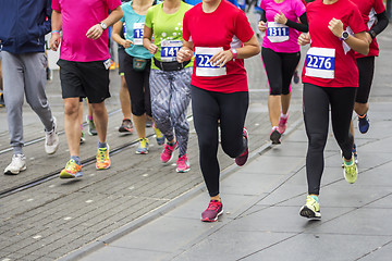 Image showing Marathon runners race in city streets, blurred motion