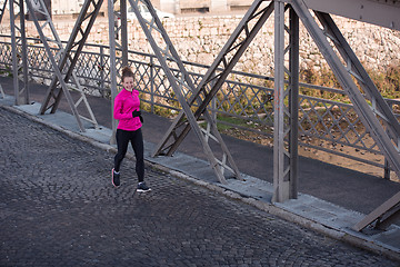 Image showing sporty woman jogging on morning