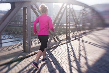 Image showing sporty woman jogging on morning