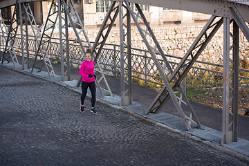 Image showing sporty woman jogging on morning