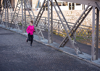 Image showing sporty woman jogging on morning