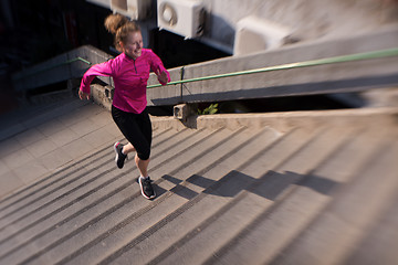 Image showing woman jogging on  steps