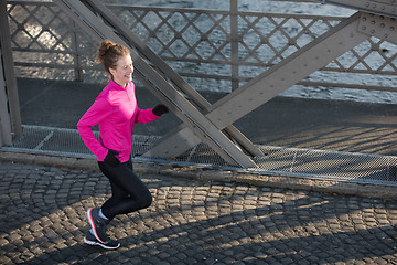 Image showing sporty woman jogging on morning