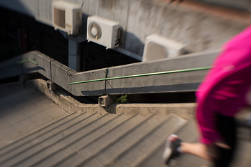 Image showing woman jogging on  steps