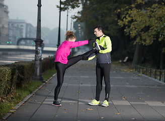 Image showing couple warming up before jogging