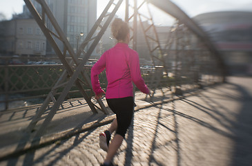 Image showing sporty woman jogging on morning