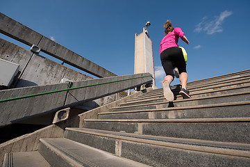 Image showing woman jogging on  steps