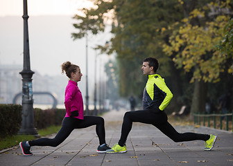 Image showing couple warming up before jogging