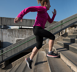 Image showing woman jogging on  steps