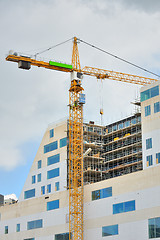 Image showing Working crane on a modern office building 