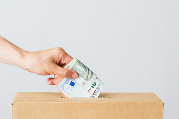 Image showing man putting euro money into donation box