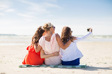 Image showing happy women taking selfie by smartphone on beach