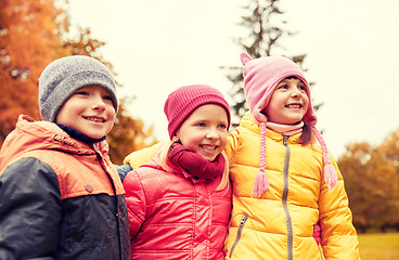 Image showing group of happy children hugging in autumn park