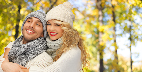 Image showing happy couple in warm clothes over autumn