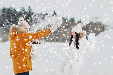 Image showing happy couple playing with snow in winter