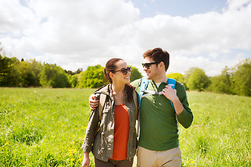 Image showing happy couple with backpacks hiking outdoors