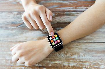 Image showing close up of hands setting smart watch with icons