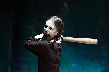 Image showing Portrait of a young girl in school uniform as killer woman