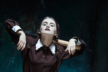 Image showing Portrait of a young girl in school uniform as killer woman