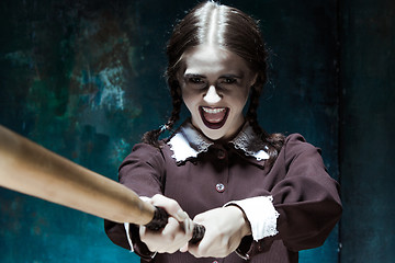 Image showing Portrait of a young girl in school uniform as killer woman