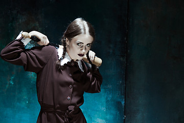 Image showing Portrait of a young girl in school uniform as killer woman