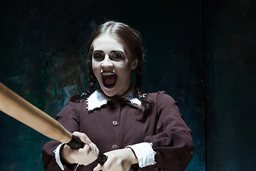 Image showing Portrait of a young girl in school uniform as killer woman