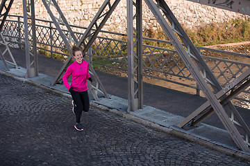 Image showing sporty woman jogging on morning