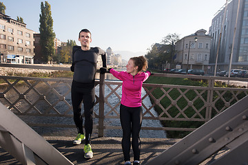 Image showing couple warming up before jogging