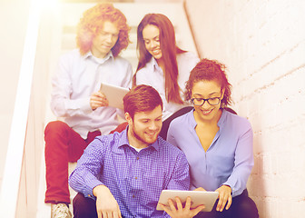 Image showing team with tablet pc computer sitting on staircase