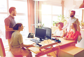 Image showing happy creative team talking in office