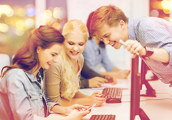 Image showing students with computer monitor and smartphones