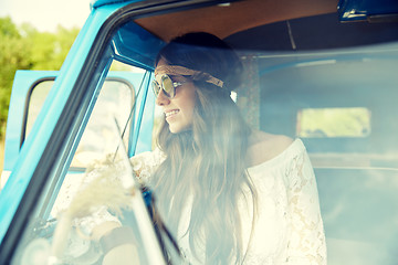 Image showing smiling young hippie woman in minivan car