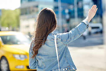 Image showing young woman or girl catching taxi on city street