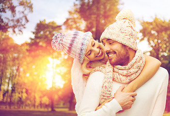 Image showing happy couple in warm clothes over autumn