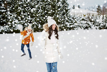 Image showing happy couple playing snowballs in winter