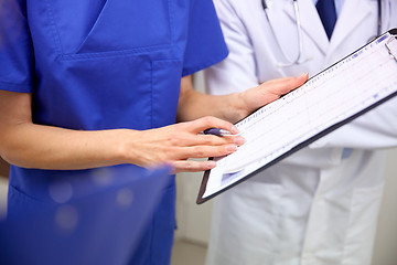 Image showing close up of doctors with clipboard at hospital